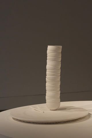 Image: The sculpture features a tall stack of bowls on a plate with chopsticks.