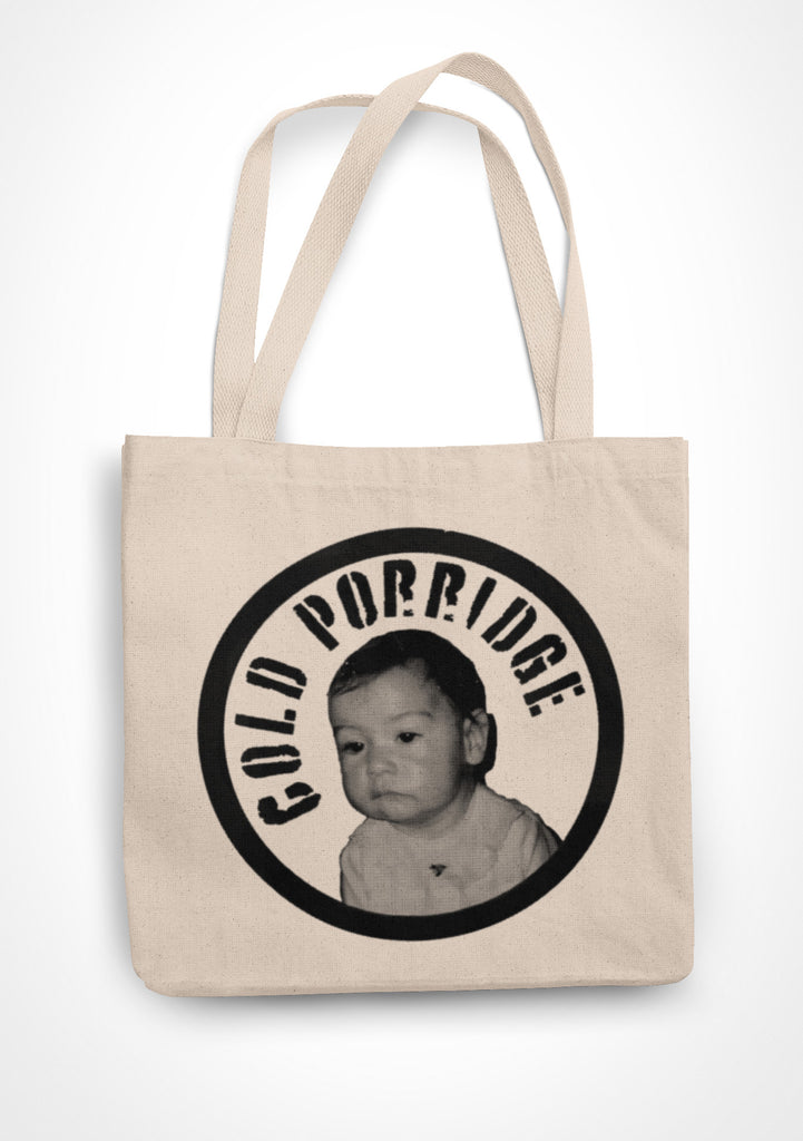 Natural coloured tote bag with a black image of the Cold Porridge expressionless baby with the text Cold Porridge surrounding it in a circle.